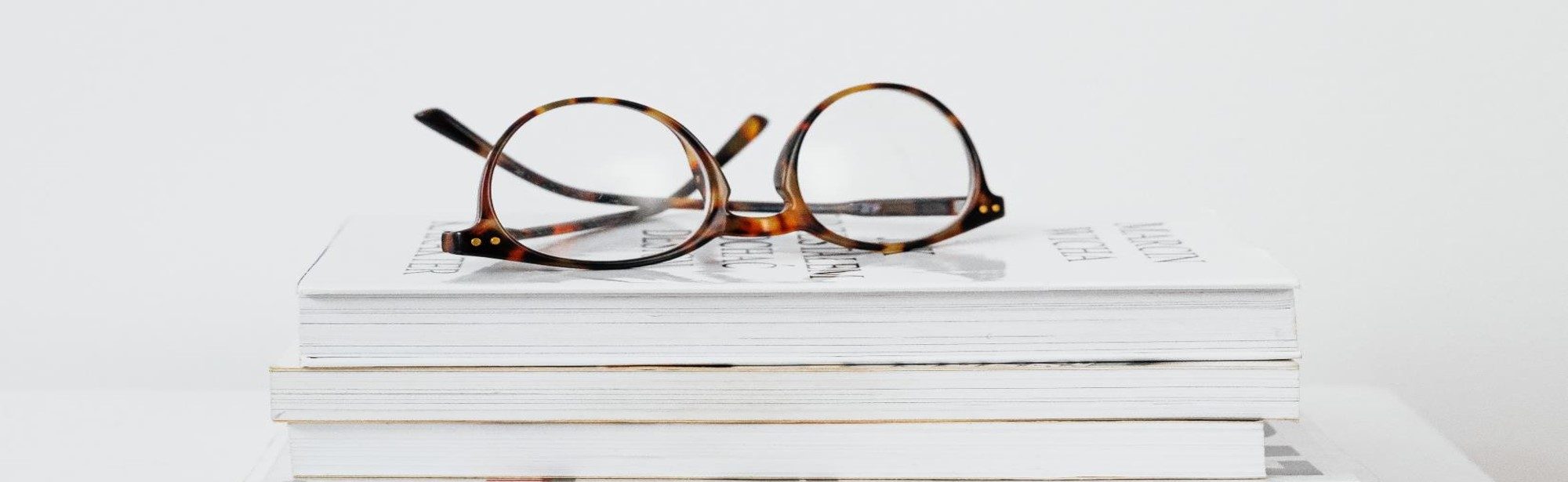glasses on stack of books